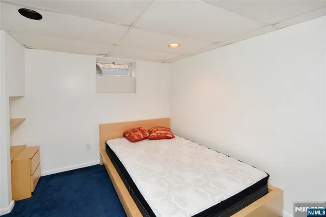 a room with a bed and wooden floor