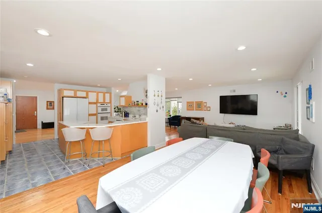 a large bedroom with a large bed and a view of living room