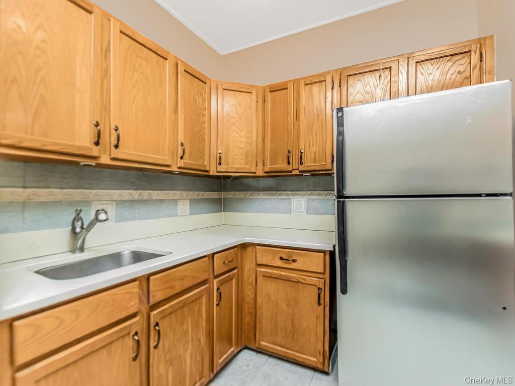 472 Gramatan Avenue, Unit O2 Mount Vernon, NY 10552 - Photo 4 of 13 a kitchen with stainless steel appliances granite countertop a sink a refrigerator and cabinets