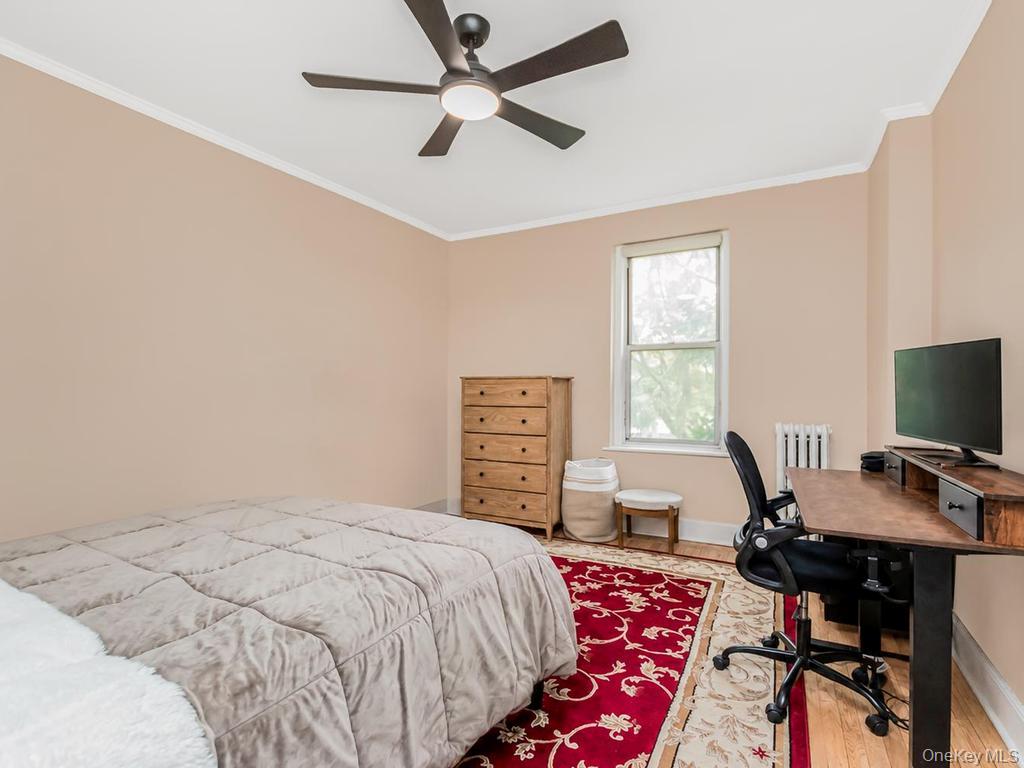 472 Gramatan Avenue, Unit O2 Mount Vernon, NY 10552 - Photo 8 of 13 a bedroom with a bed and a desk
