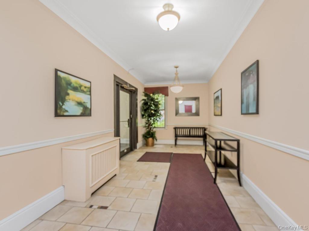 472 Gramatan Avenue, Unit O2 Mount Vernon, NY 10552 - Photo 10 of 13 a view of a hallway with the couches and dining table