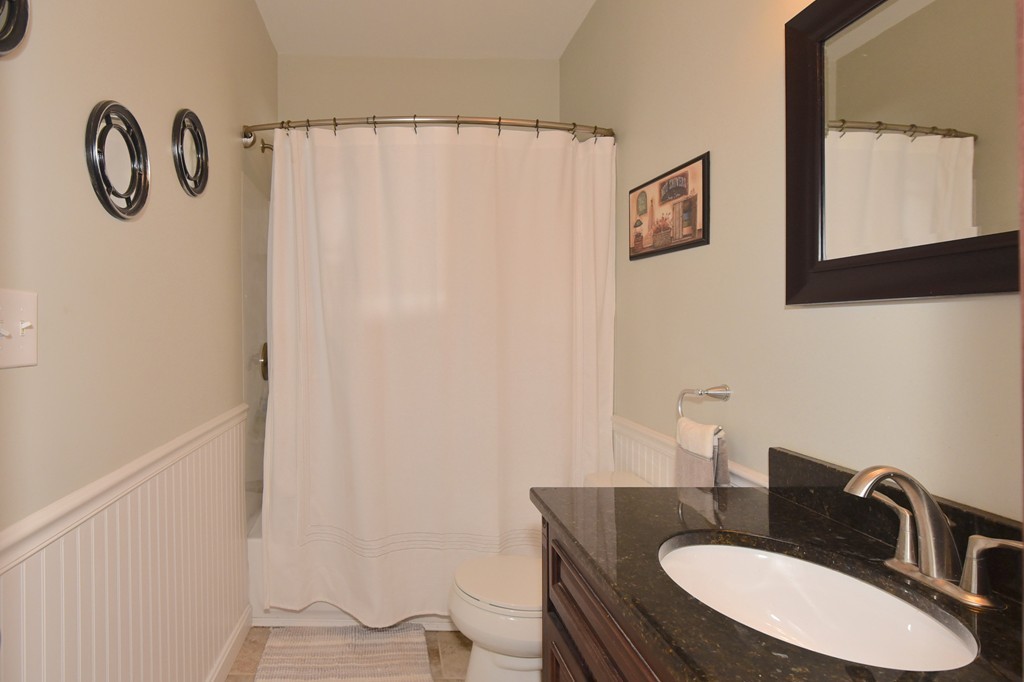 7 Chadwick Street Worcester, MA 01605 - Photo 19 of 30 a bathroom with a granite countertop sink and a mirror