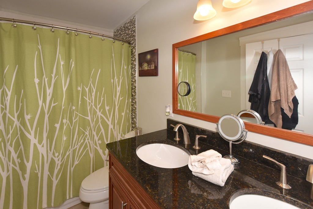 7 Chadwick Street Worcester, MA 01605 - Photo 21 of 30 a bathroom with a granite countertop sink and a mirror