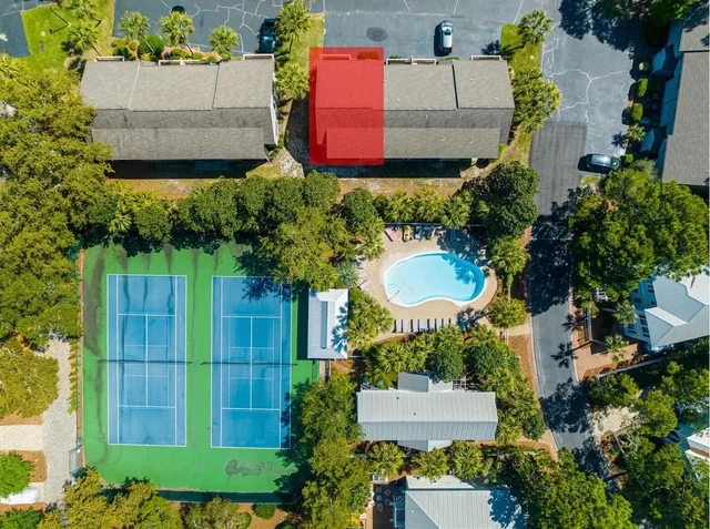 an aerial view of a house with a yard and a large pool