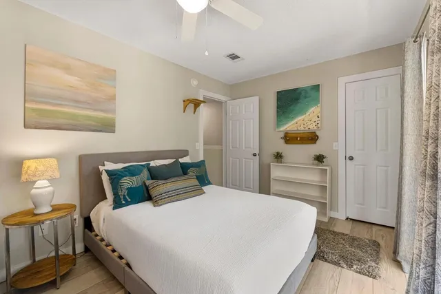 a bedroom with a bed and a painting on the wall