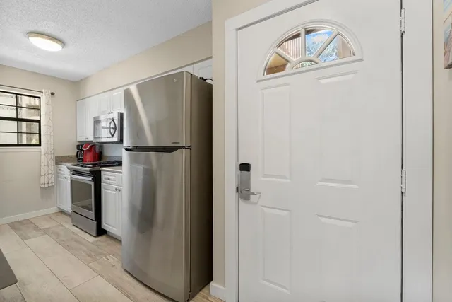 a kitchen with a refrigerator and a stove