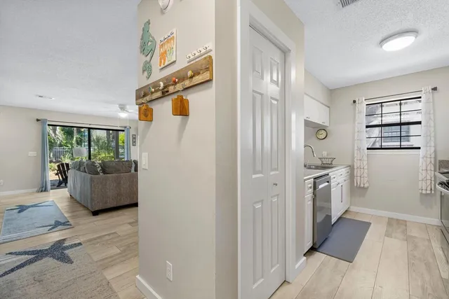 a hallway with cabinets and wooden floor