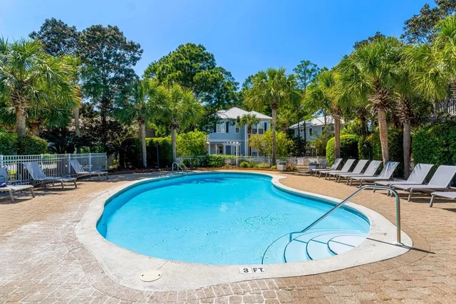 a view of a swimming pool with lounge chairs