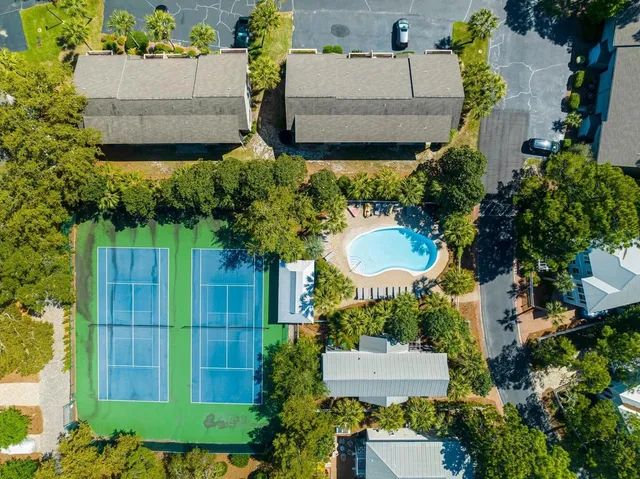 an aerial view of a house with a yard and a large pool