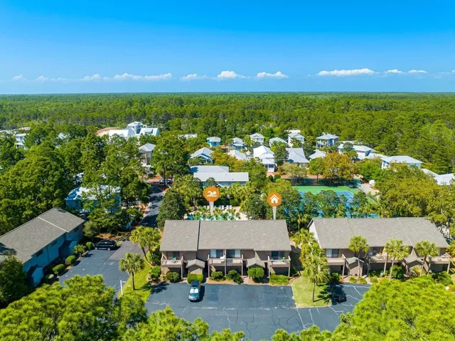 an aerial view of residential houses with outdoor space and lake view