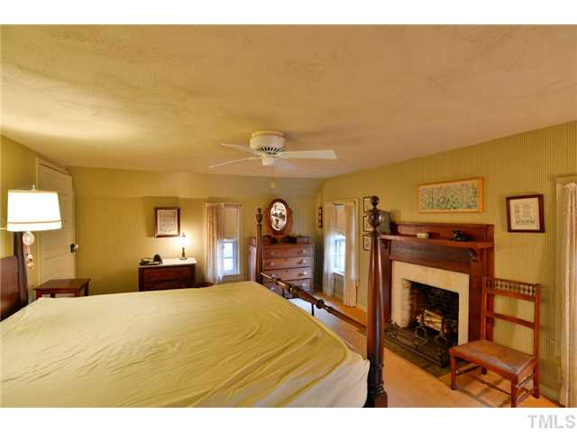 2131 Marions Ford Road Chapel Hill, NC 27516 - Photo 20 of 25 Upstairs bedroom with fireplace.