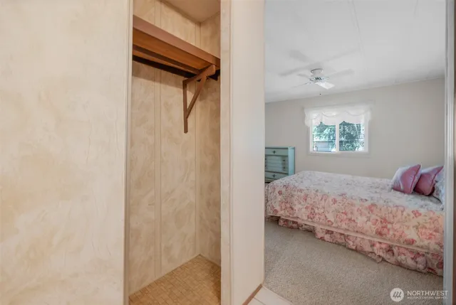 a bedroom with a bed and a window