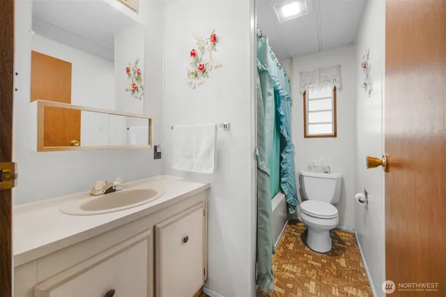 a bathroom with a sink toilet and a mirror