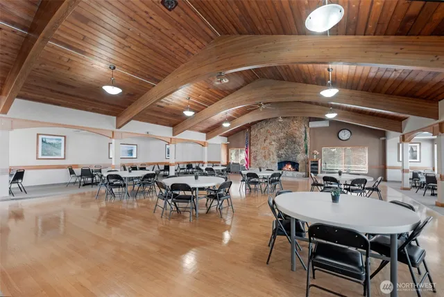 a dining hall with furniture and a large window