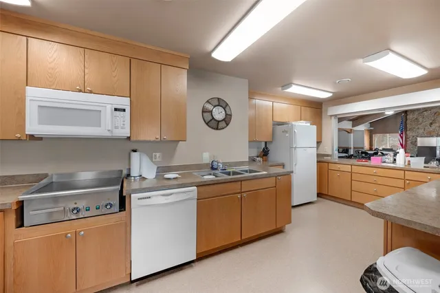 a kitchen with stainless steel appliances a sink a stove and a refrigerator