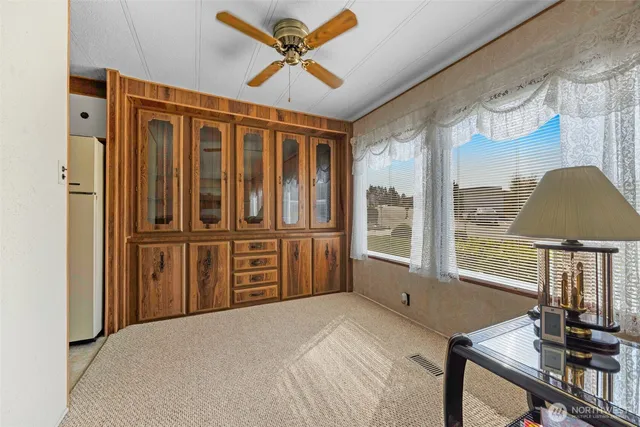 a view of a bedroom with furniture window and wooden floor