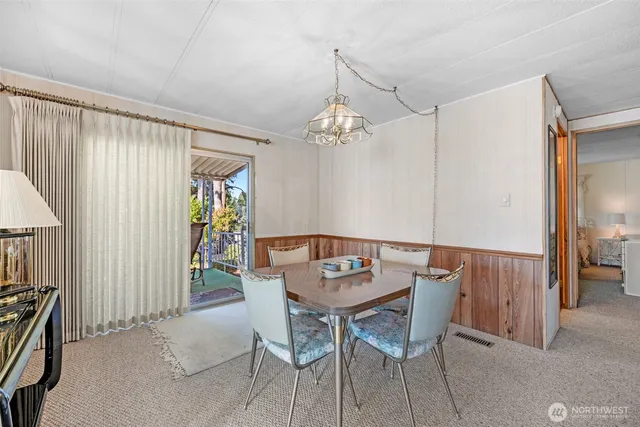 a view of a dining room with furniture and chandelier