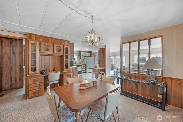 a view of a dining room with furniture large windows and wooden floor