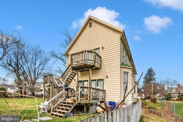 a living room with furniture a dining table and a window