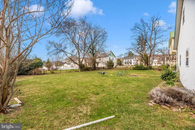 a living room with furniture a fireplace and a table