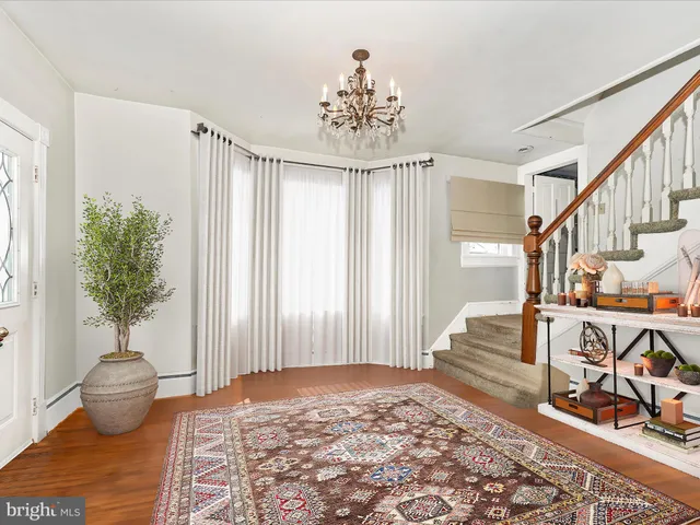 a view of an empty room with window and fireplace