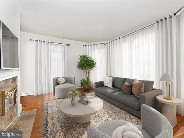 a kitchen with stainless steel appliances granite countertop a refrigerator a sink a stove and a wooden floors