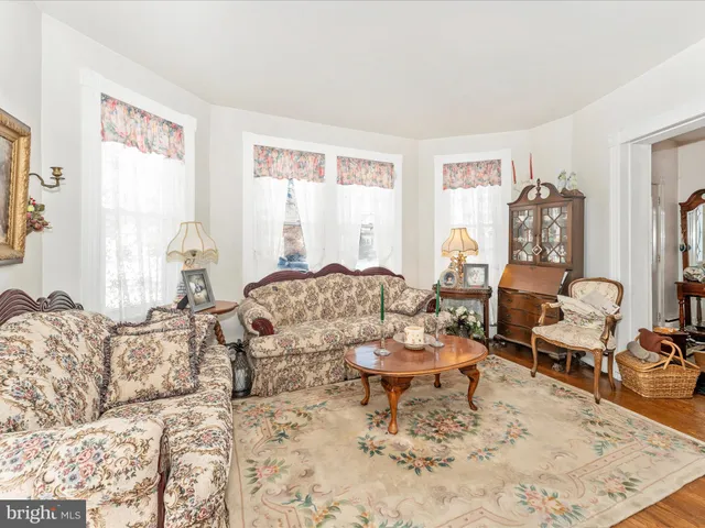 a kitchen with stainless steel appliances granite countertop a stove top oven a dining table and chairs with wooden floor