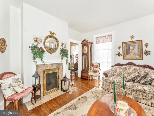 a view of a dining room with furniture large windows and wooden floor
