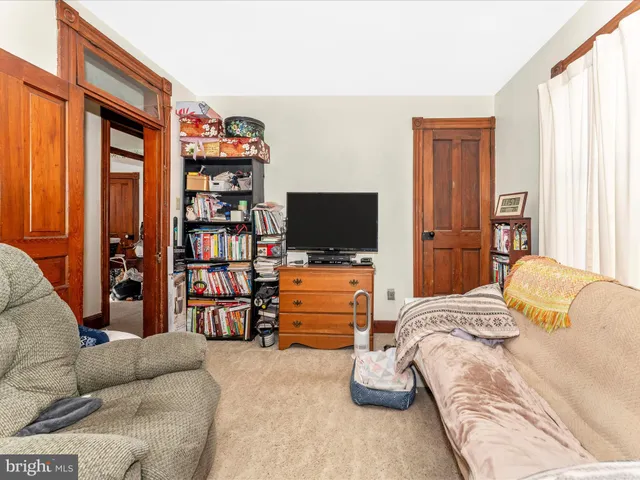 a bedroom with a bed dresser and a window