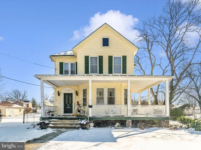 a view of swimming pool with lawn chairs and plants