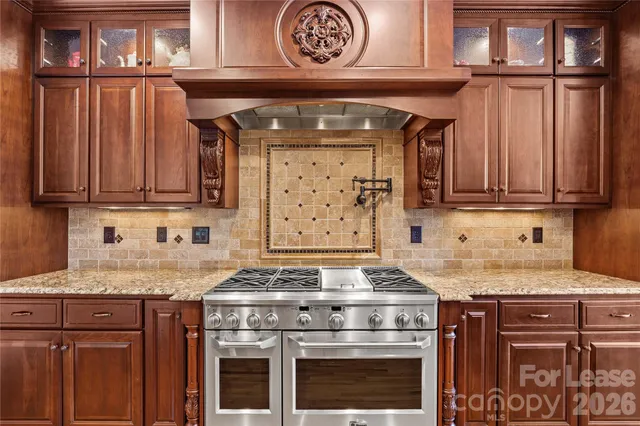 a kitchen with stainless steel appliances granite countertop a stove and a microwave