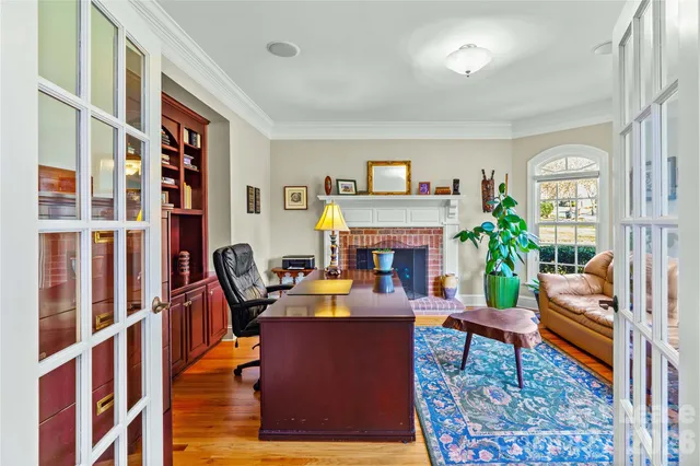 a living room with furniture fireplace and a large window