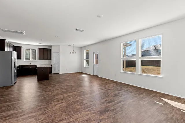a kitchen with a granite countertop sink and a wooden floor