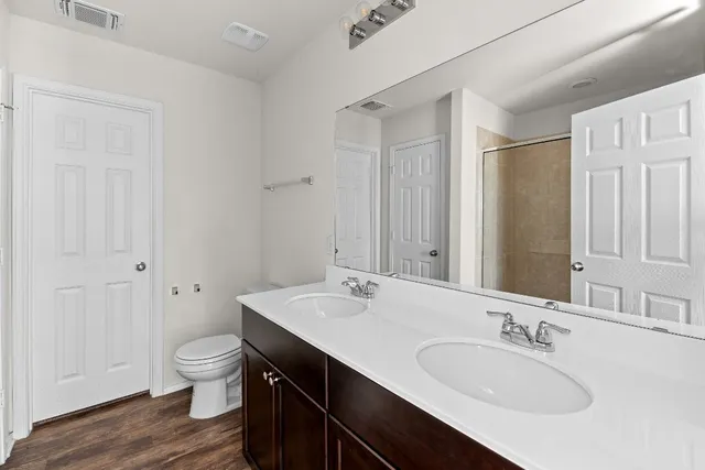 an empty room with windows and cabinet