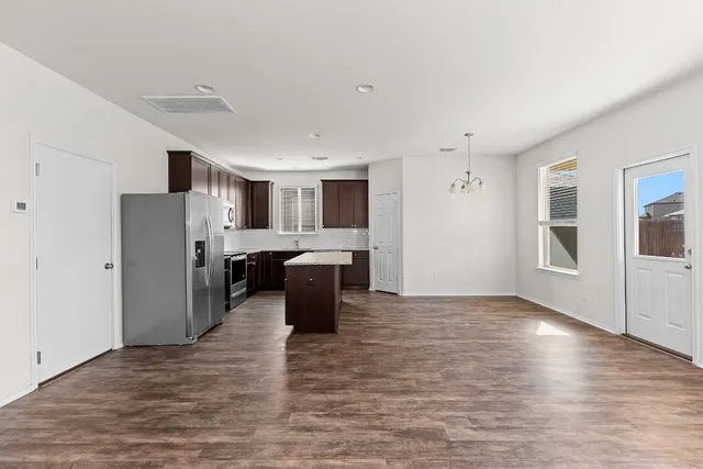 an aerial view of multiple houses with a yard