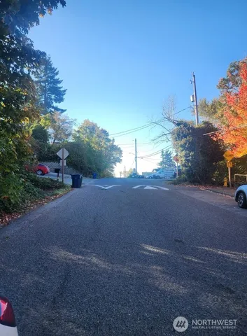 a view of a street with a building in the background