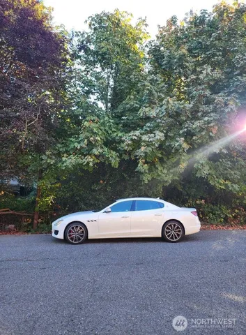 a car parked in a field next to a road
