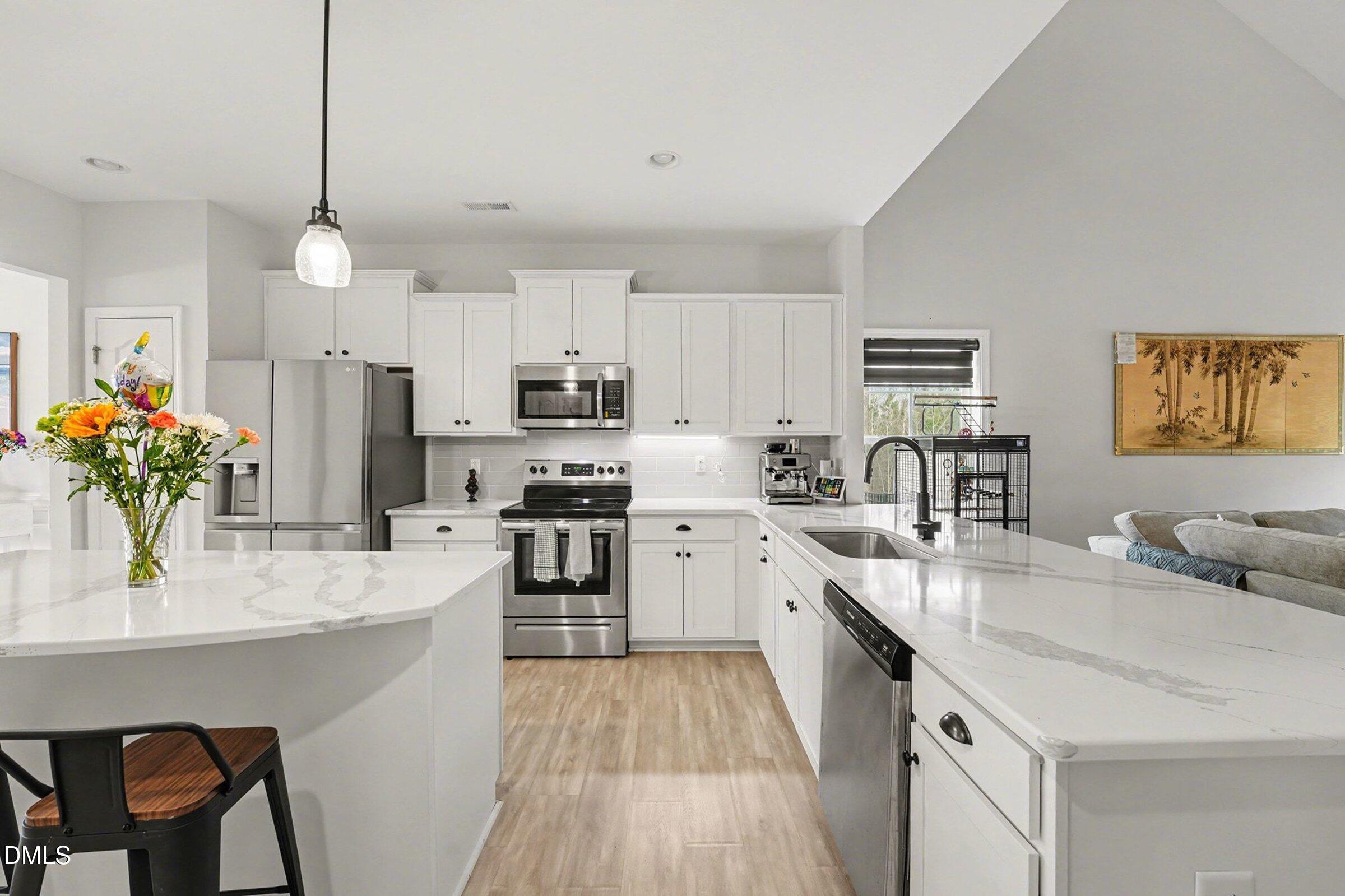 365 Timber Skip Drive Spring Lake, NC 28390 - Photo 12 of 33 a kitchen with stainless steel appliances kitchen island granite countertop a sink stove and refrigerator
