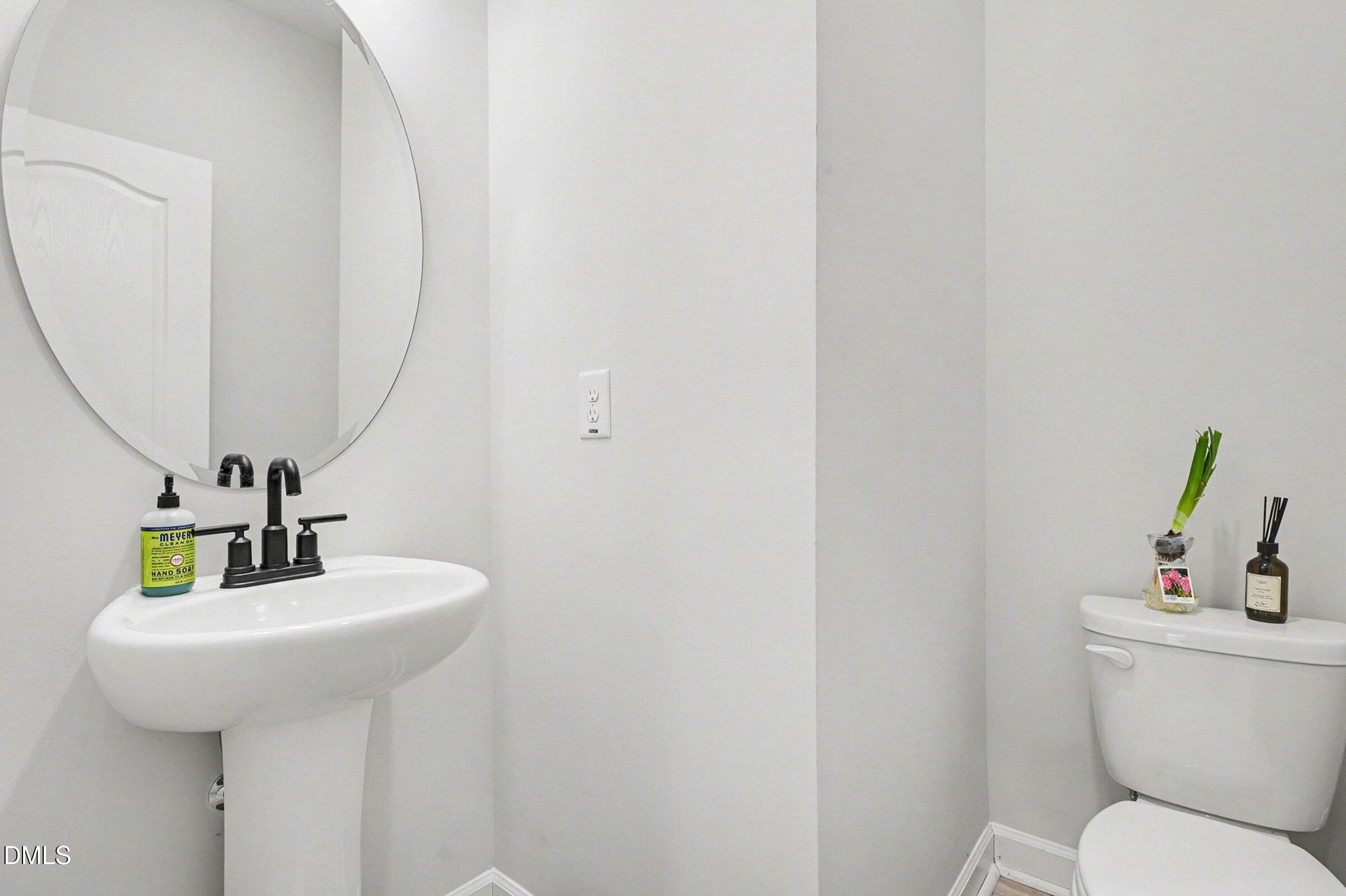 365 Timber Skip Drive Spring Lake, NC 28390 - Photo 14 of 33 a bathroom with a toilet sink and mirror