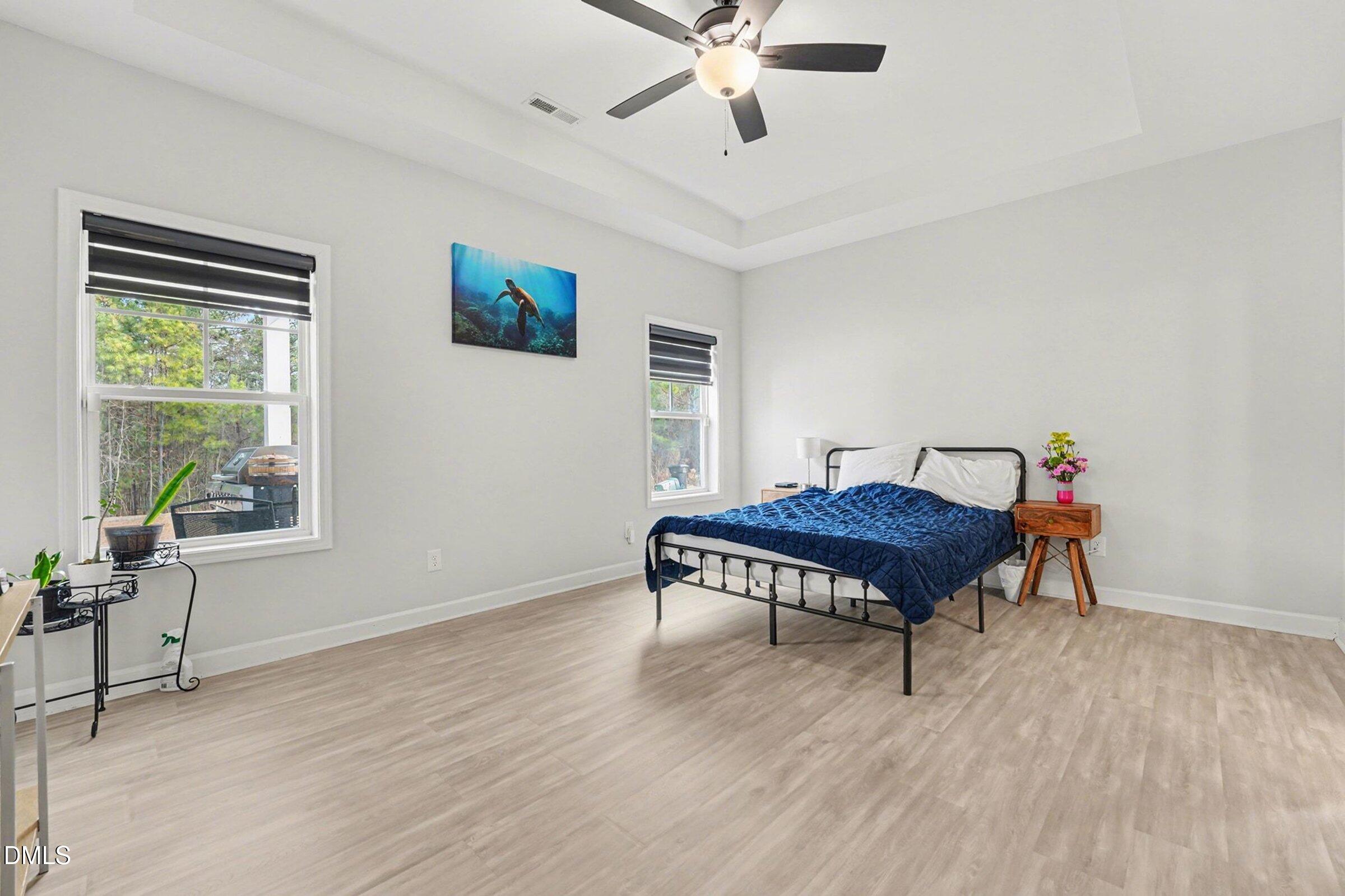 365 Timber Skip Drive Spring Lake, NC 28390 - Photo 15 of 33 a bedroom with a bed and wooden floor