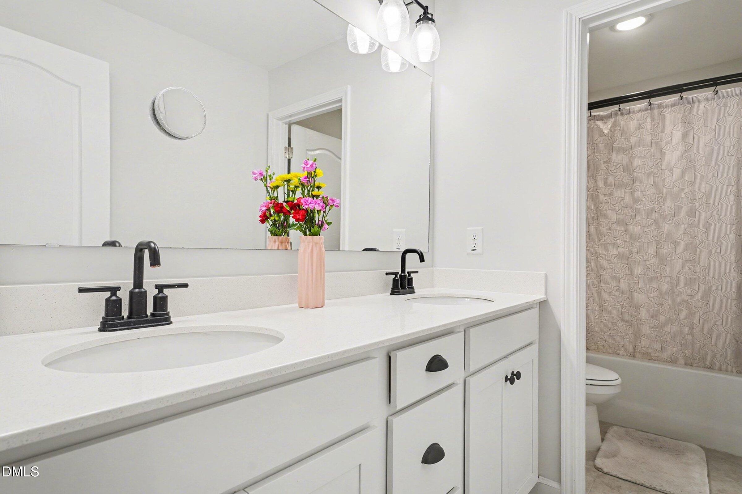365 Timber Skip Drive Spring Lake, NC 28390 - Photo 17 of 33 a bathroom with a sink and a mirror