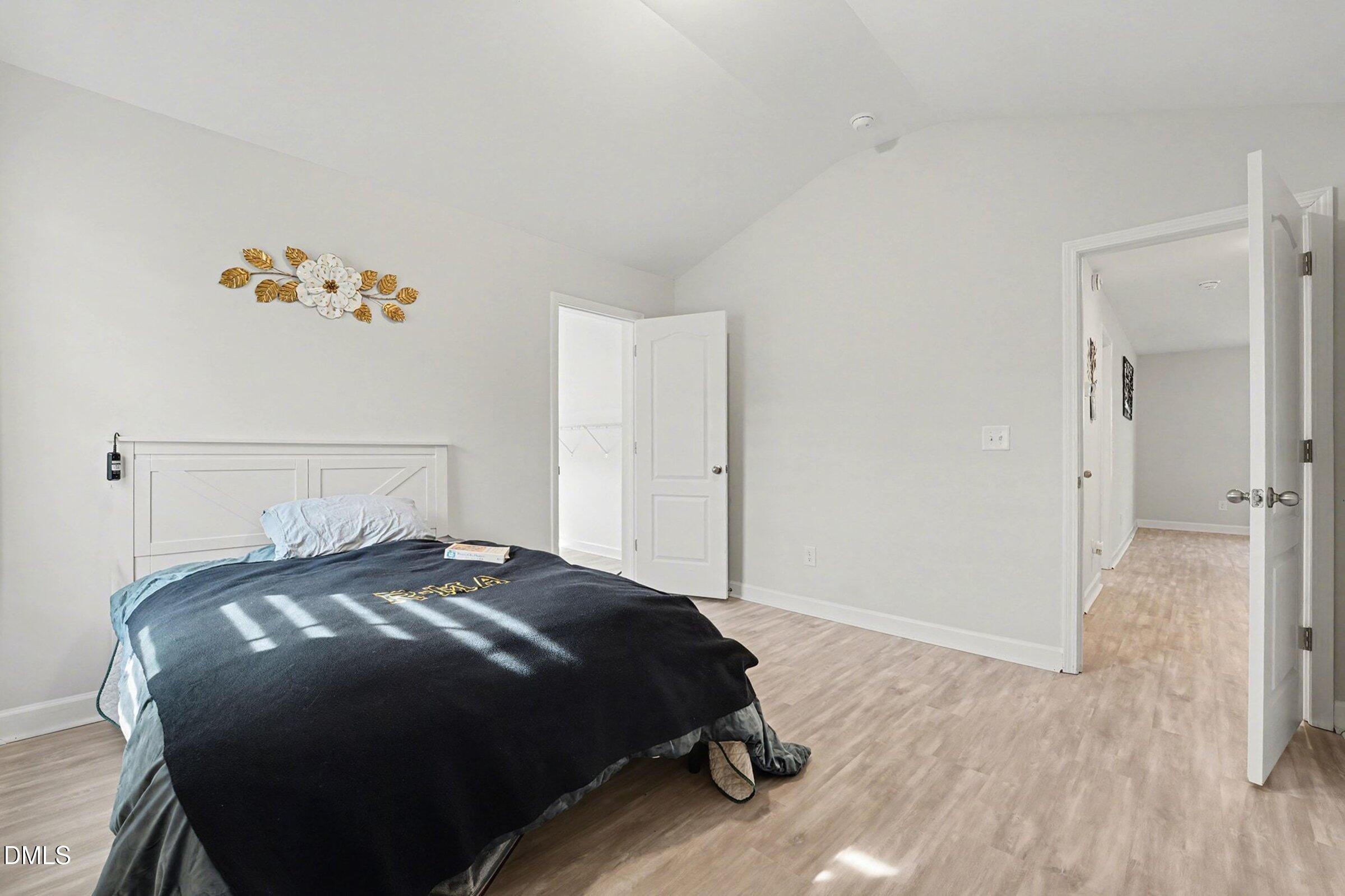 365 Timber Skip Drive Spring Lake, NC 28390 - Photo 20 of 33 a bedroom with a bed and a painting on the wall