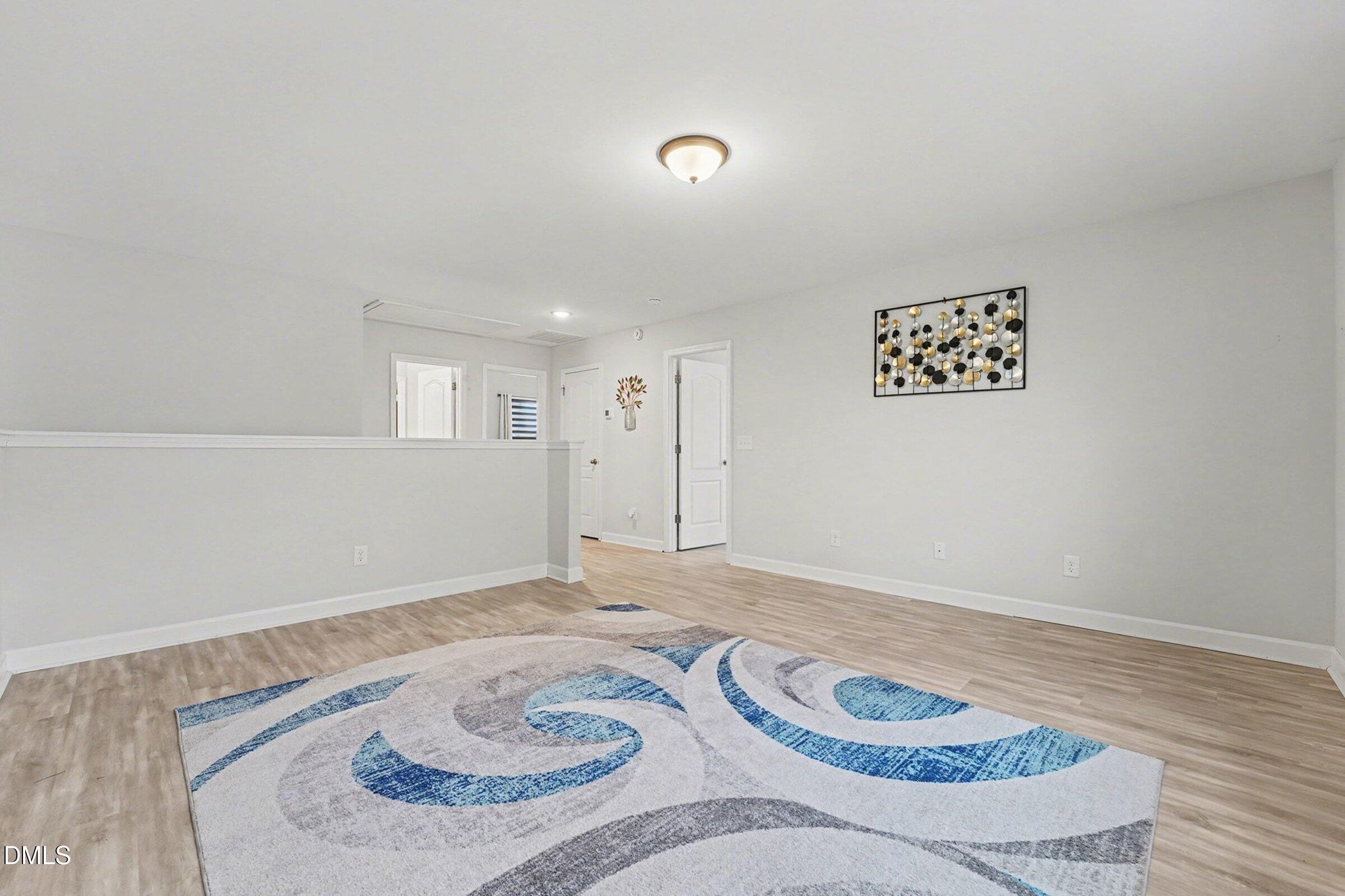 365 Timber Skip Drive Spring Lake, NC 28390 - Photo 24 of 33 a view of a livingroom with wooden floor and white walls