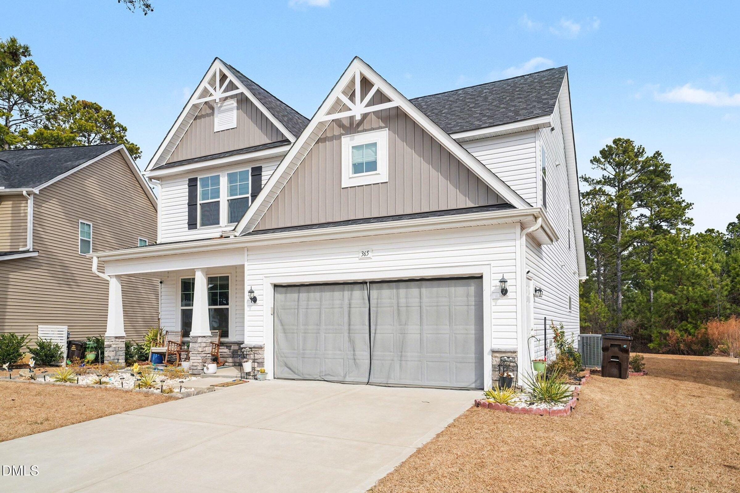 365 Timber Skip Drive Spring Lake, NC 28390 - Photo 3 of 33 a front view of a house with a yard and garage