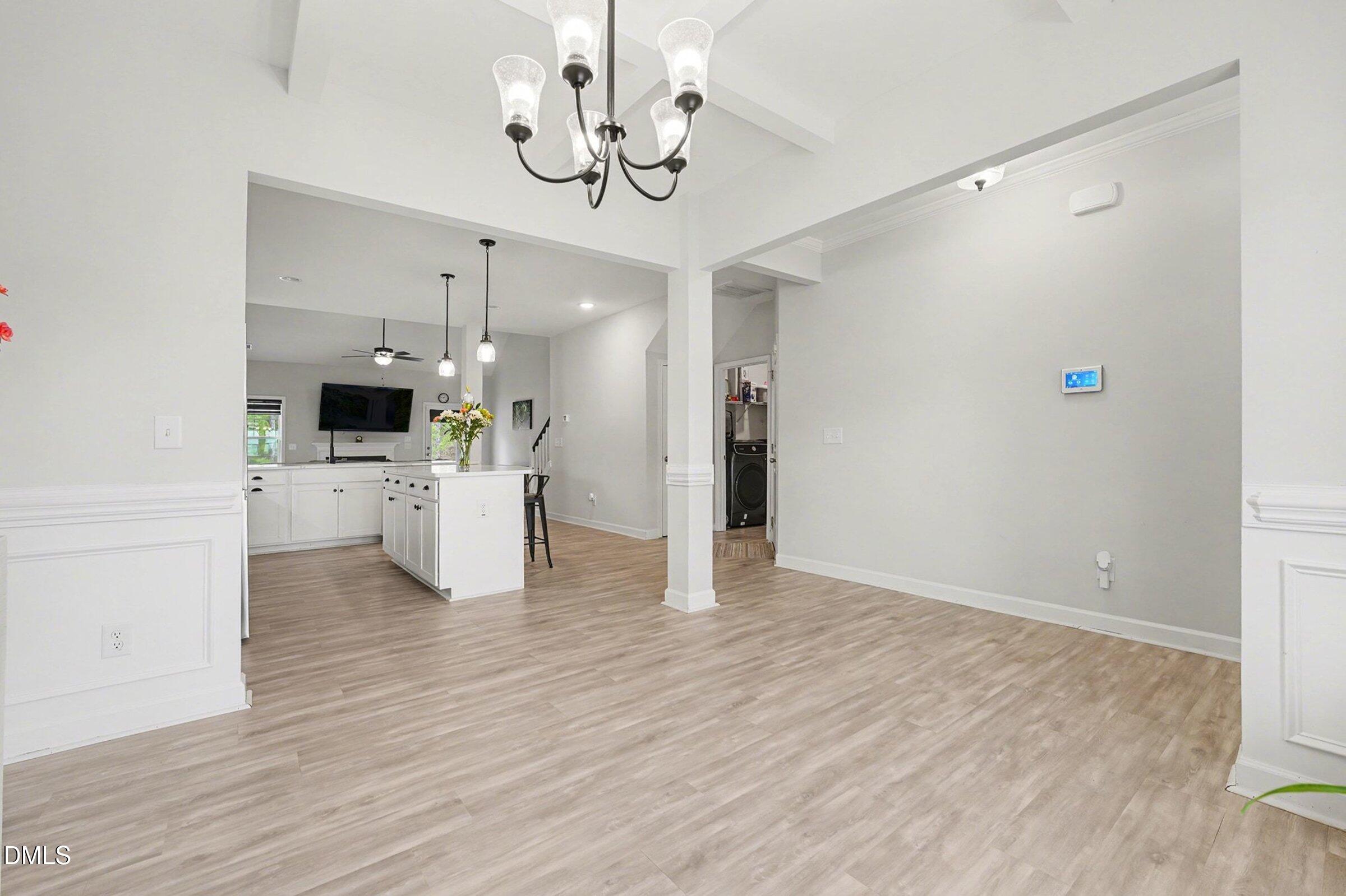 365 Timber Skip Drive Spring Lake, NC 28390 - Photo 10 of 33 a view of a kitchen with a refrigerator a microwave and a wooden floor
