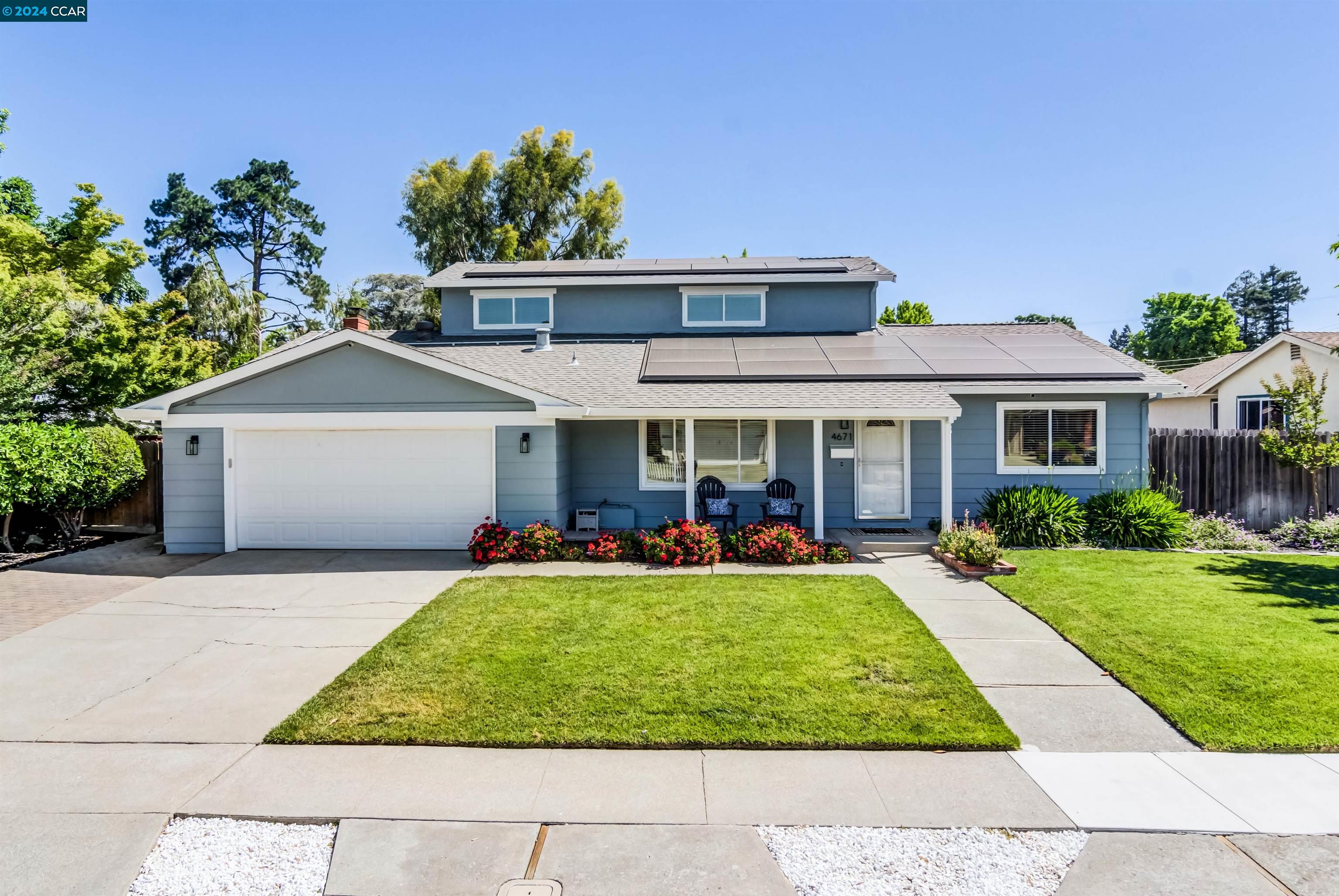 a view of a house with a yard patio and fire pit