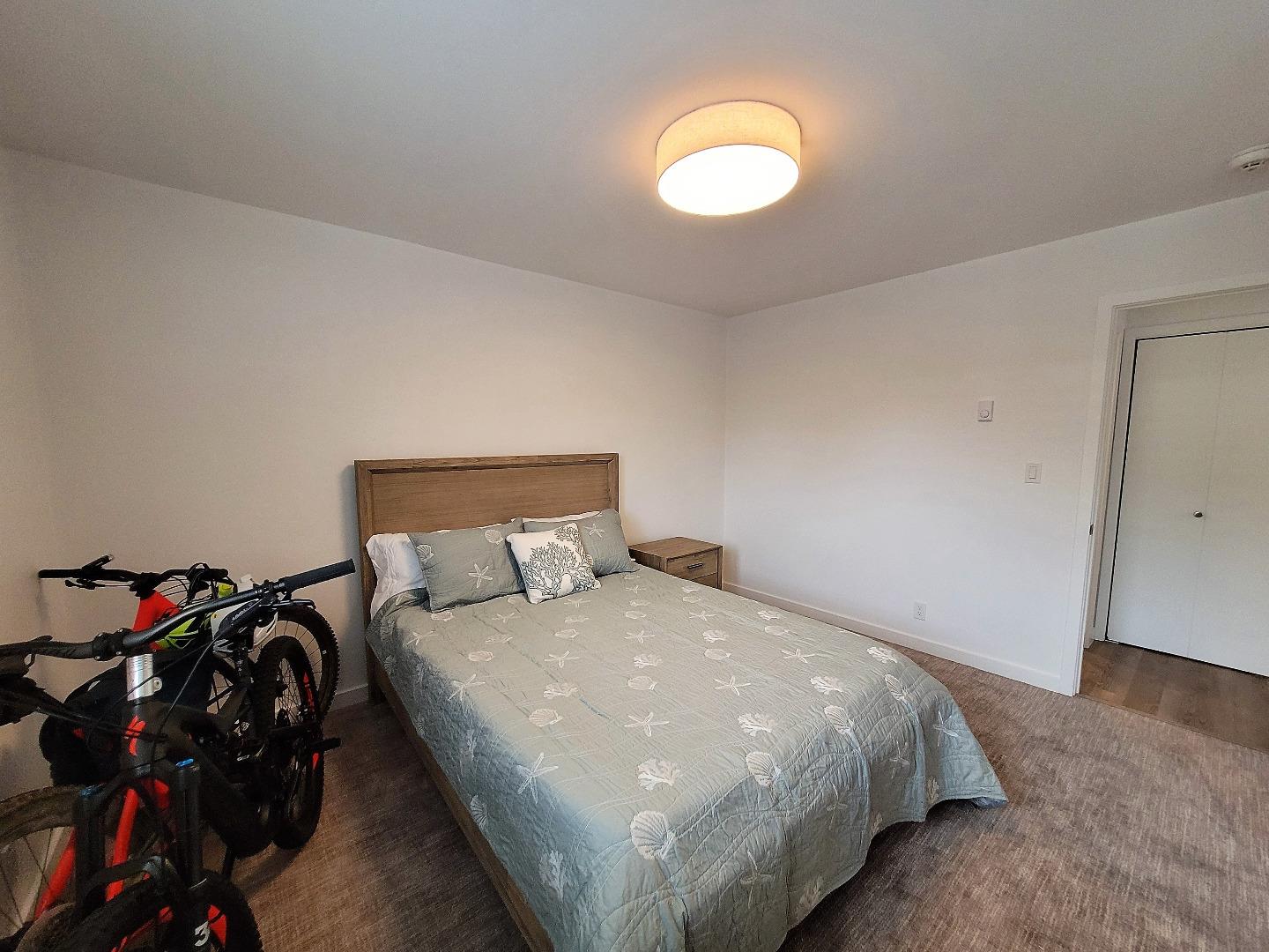 101 Shell Road, Unit 234 Watsonville, CA 95076 - Photo 15 of 18 a bed room with a bed and a tv
