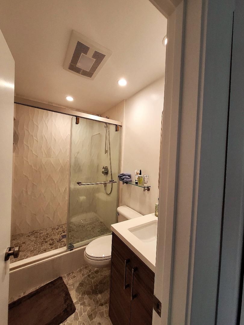 101 Shell Road, Unit 234 Watsonville, CA 95076 - Photo 16 of 18 a bathroom with a granite countertop sink a toilet and shower
