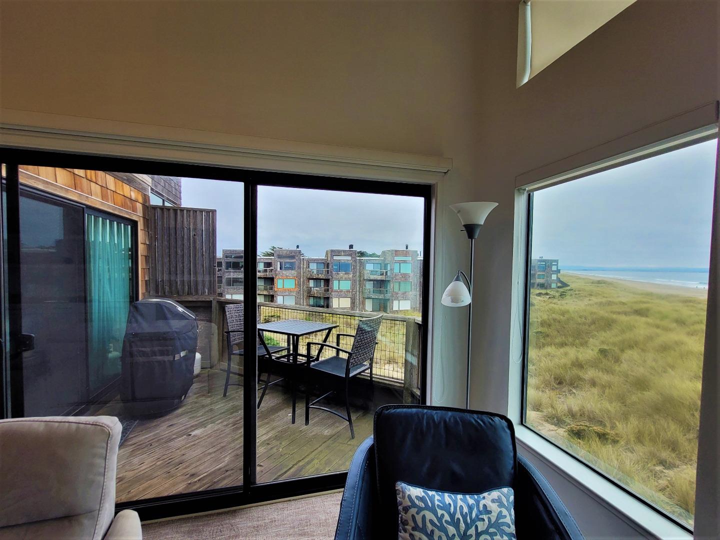 101 Shell Road, Unit 234 Watsonville, CA 95076 - Photo 8 of 18 a living room with furniture and a floor to ceiling window