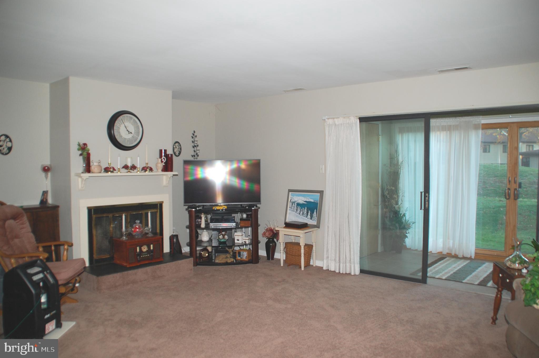 12 Centennial Road Telford, PA 18969 - Photo 10 of 35 The Living Room features a wood-burning fireplace.